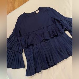 Navy pleated blouse with dramatic sleeves